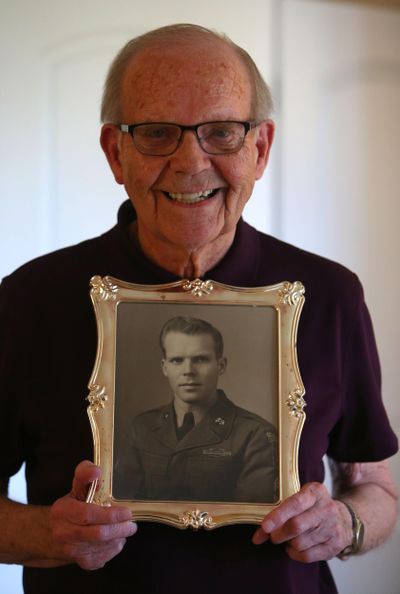 Ty Lovelace holds his 1951 portrait at his home in Eugene, Ore. (Brian Davies / AP)