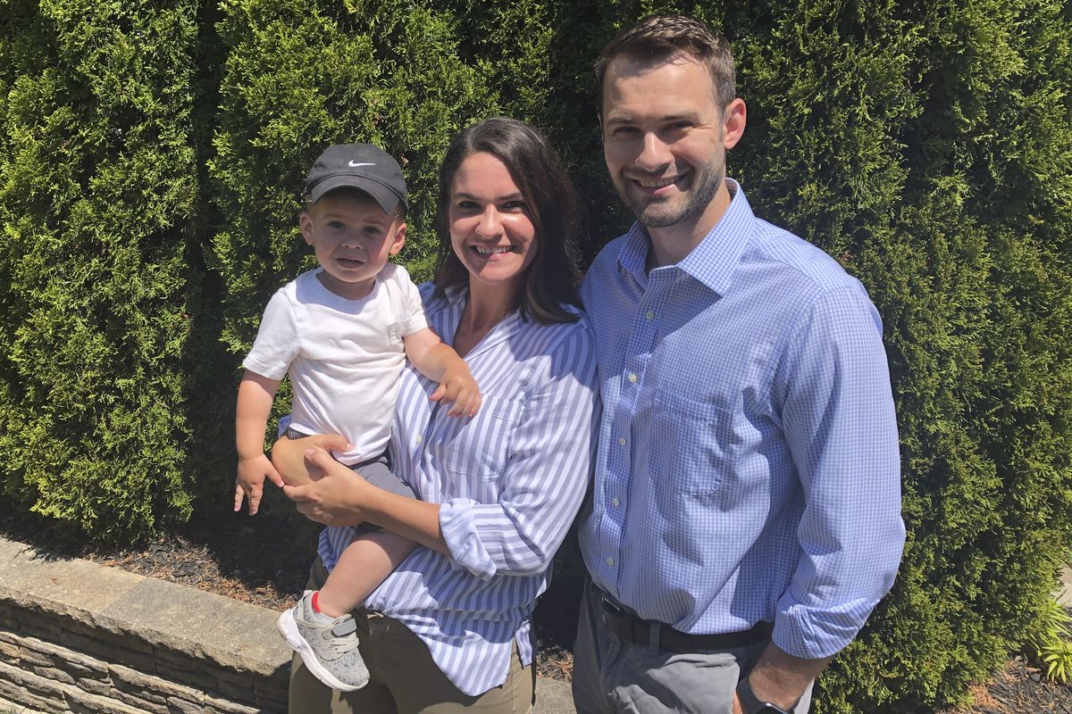 This photo from June 16, 2020 shows Maddy, center, and Brian Bascom, right, both members of the Millennial generation, as they pose for a photo with their son, Jack in their backyard in Cincinnati. Sometimes at odds, America’s two largest generations have something to agree on: the coronavirus pandemic has smacked many at a pivotal time in their lives. For baby boomers, named for the post-World War II surge of births, that means those who retired or are nearing retirement age are seeing their retirement accounts appearing unreliable while their health is at high risk. Millennials, who became young adults in this century, are getting socked again as they were still recovering from the Great Recession.  (Dan Sewell)