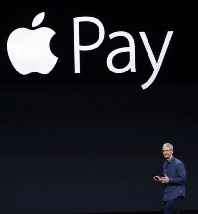 Apple CEO Tim Cook introduces the new Apple Pay product in Cupertino, Calif., on Sept. 9, 2014. The Consumer Financial Protection Bureau is ordering tech giants to disclose how they operate their payment networks.  (Associated Press )