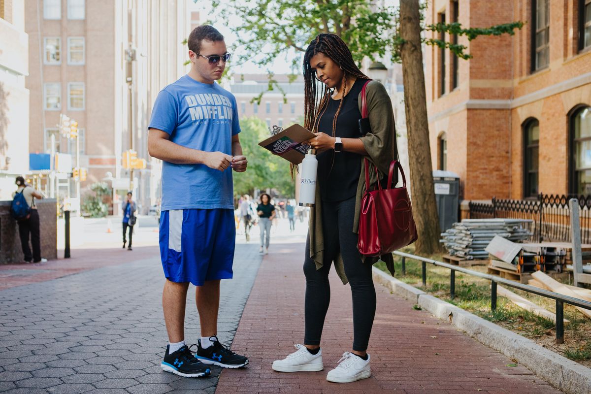 Coby Rich, 20, a junior at the University of Pennsylvania, helps Chelsea Perry, 30, an MBA student at the Wharton School of Business, register to vote during an All in PA voter drive on campus in Philadelphia. MUST CREDIT: Photo for The Washington Post by Michelle Gustafson.  (Michelle Gustafson/For The Washington Post)