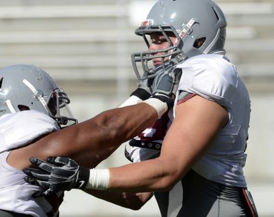 Senior Travis Long, right, played defensive end the past three seasons but is now a “buck” linebacker. (Dan Pelle)