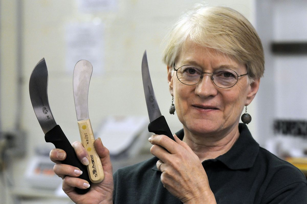 Joyce Bailey Vannoy shows some of the many knifes for boning and skinning that are sold at the store. (Dan Pelle / The Spokesman-Review)