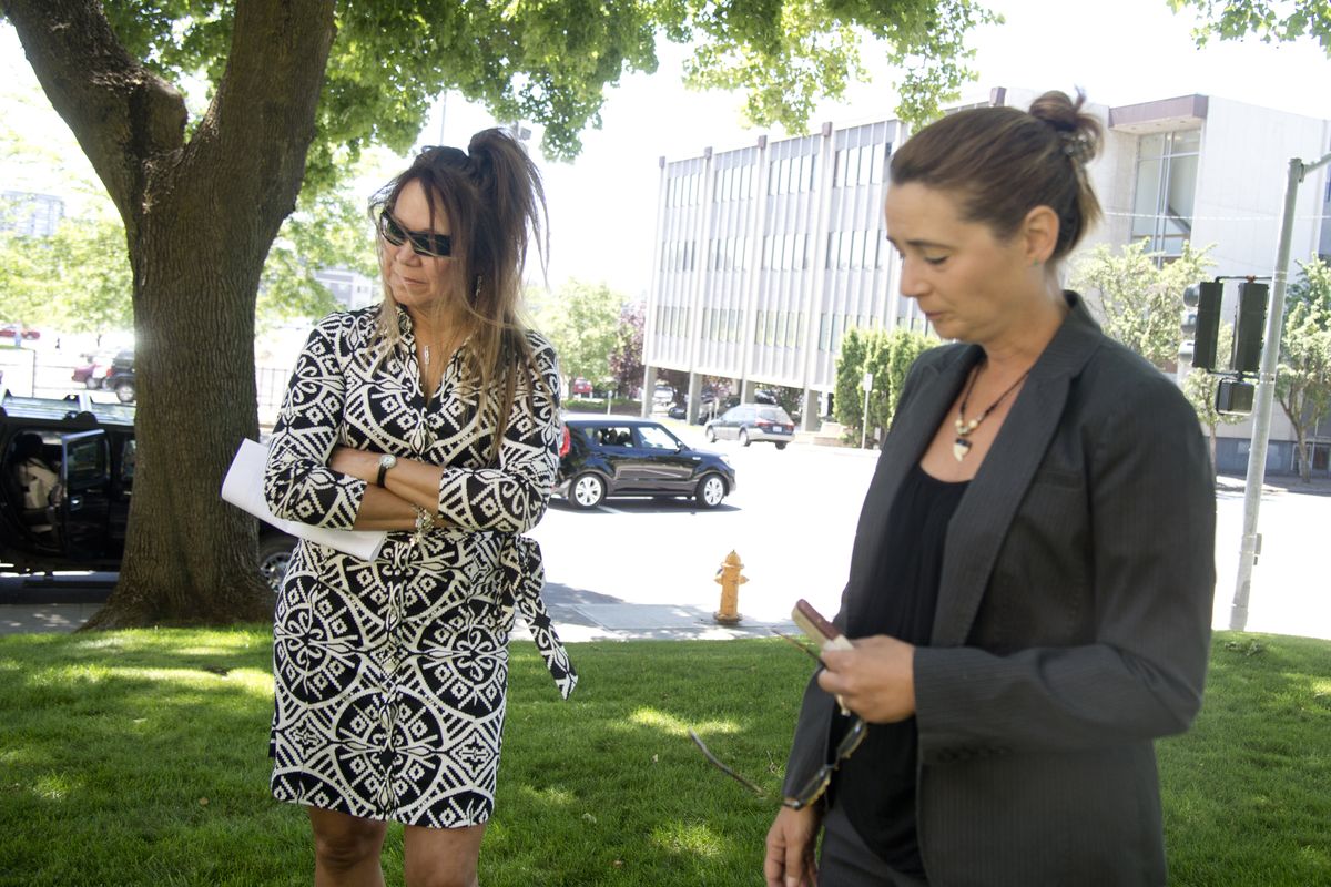 Lisa Deruyter, left, sister of murder suspect and former Pasco police officer Richard Aguirre, waits while family friend Tina Ledoux, right, speaks with the media Friday at the Spokane County Courthouse. The family and Ledoux declared their belief that Aguirre is innocent of the cold-case killing of which he is accused. (Jesse Tinsley)