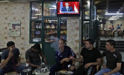 Palestinians sit in a coffee shop in Ramallah on Thursday as  President Barack Obama speaks on TV from Cairo, Egypt. In his speech, Obama said   that while Palestinians have suffered in their quest for a homeland, their protest should be nonviolent.   (Associated Press / The Spokesman-Review)