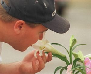 In this SR file photo, a Spokane man takes time to stop and smell the flowers.