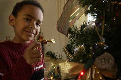 Kristopher Lovasz-Cline, 8, holds a piece of Hungarian candy that hangs on the Christmas tree in their home. His grandmother, Eva Lovasz, was born and raised in Hungary and decorates the tree with the candy, a Hungarian tradition. They live in Coeur d'Alene.
(Jesse Tinsley / The Spokesman-Review)
