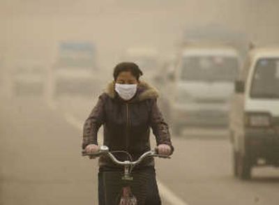 
Heavy pollution forces a cyclist in Lanzhou, in China's Gansu province, to wear a face mask  in this December  2006 photo. Associated Press
 (File Associated Press / The Spokesman-Review)