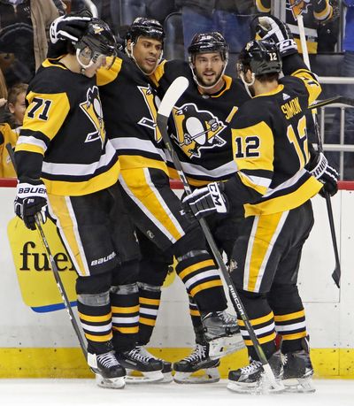 Penguins’ Ryan Reaves, second from left, celebrates his goal with Evgeni Malkin (71), Kris Letang (58), and Dominik Simon (12) in the second period against the Los Angeles Kings Thursday night in Pittsburgh. (Gene J. Puskar / Associated Press)