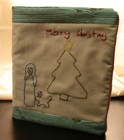 Create a family Christmas book to record your memories of the holidays over the years. Personalize the book with a cover embroidered after tracing a child's drawing. (Megan Cooley)