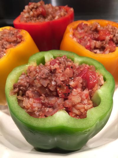 Cut carbs by stuffing riced cauliflower – instead of rice – into the belly of bell peppers. (Lorie Hutson Special to Food)