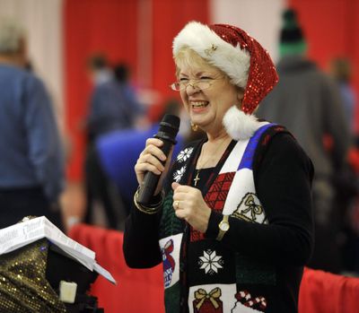 Sissy Starr sings holiday songs to the crowd waiting in line at the Christmas Bureau on Thursday. (Dan Pelle)