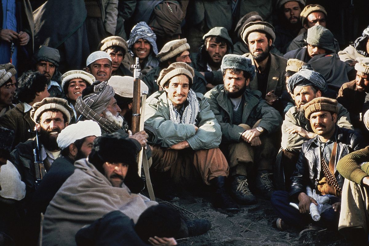 Afghan guerrilla leader, Ahmad Shah Massoud, center, is surrounded by Mujahideen commanders at a meeting of the rebels in the Panjshir Valley in northeast Afghanistan in 1984. In August 2021, the last remnants of Afghanistan’s shattered security forces have vowed to resist the Taliban in the remote Panjshir Valley north of Kabul that has defied conquerors before. Under the leadership of Massoud, fighters in the Panjshir Valley held off the Soviets in the 1980s and the Taliban a decade later. Any attempt to re-enact his exploits appears likely to fail, posing little threat to the country’s new Taliban rulers.  (Jean-Luc Bremont)