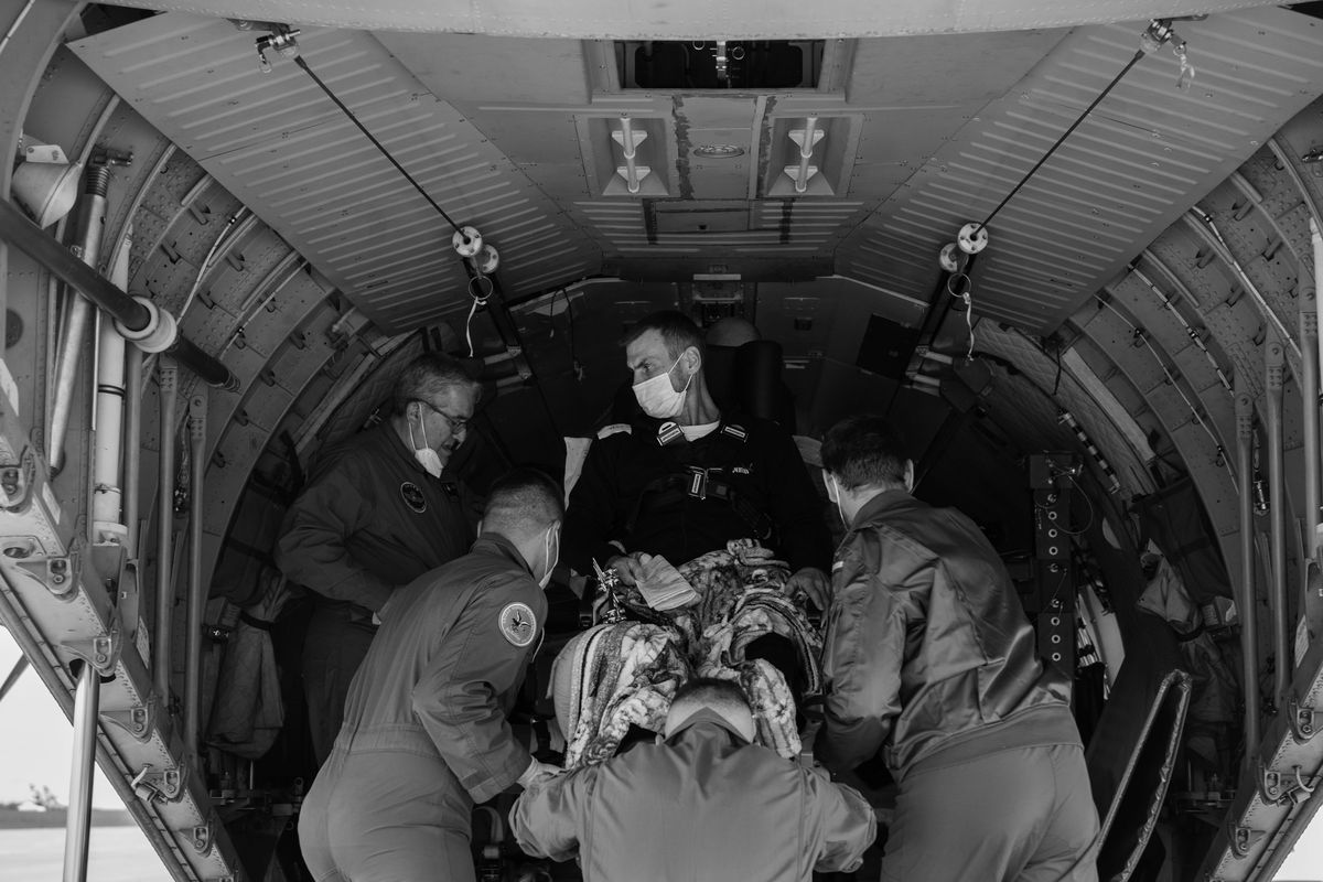 A patient with leg injuries is loaded into a Spanish military plane at the airport in Rzeszow, Poland, to be transported to Zaragoza, Spain, for treatment. Several western European nations rely on paramedic teams like this one to enter Ukraine and evacuate the patients.   (Photo by Kirsten Luce)