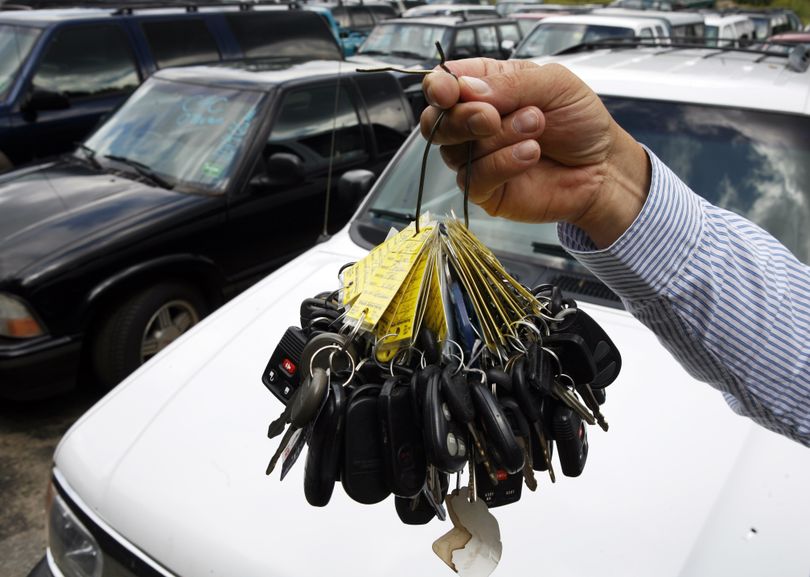 ORG XMIT: MEPW101 Sales manager Mark Hranicky holds up a bunch of keys to some of the 90 cars that were traded in under the federal government's Cash for Clunkers program, on a lot at Lee Toyota in Topsham, Maine, Monday, Aug. 24, 2009. As the Cash for Clunkers program expires, the industry goes back to confronting the worst sales slump in 25 years. (AP Photo/Pat Wellenbach) (Pat Wellenbach / The Spokesman-Review)