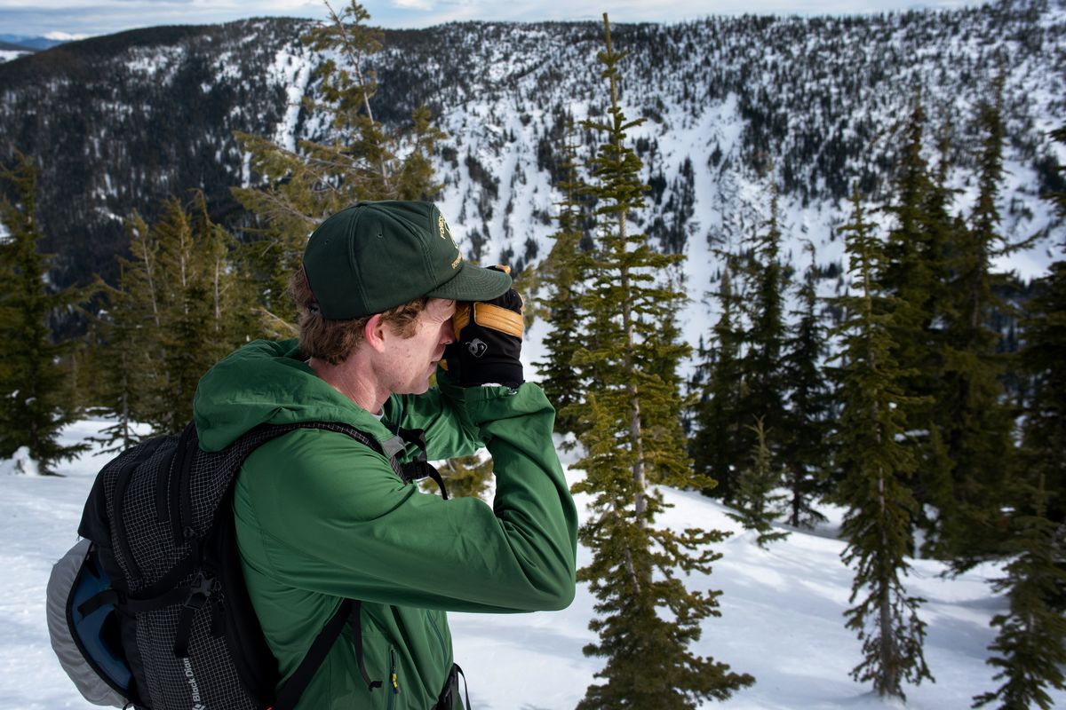 Ryan Matz, an avalanche forecaster with the U.S. Forest Service, examines a nearby ridge looking for signs of avalanches near Mullan, Idaho, on Monday.  (Eli Francovich/The Spokesman-Review)