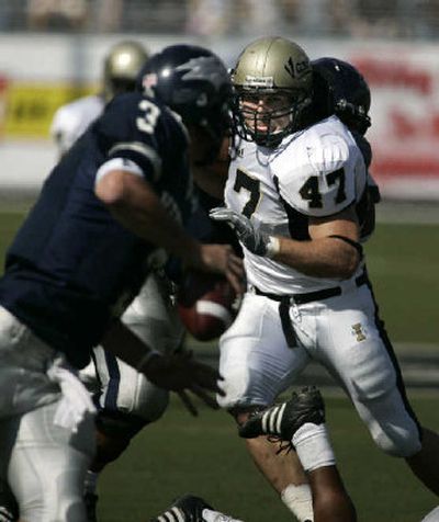 
Idaho senior middle linebacker Cole Snyder bears down on Nevada quarterback Jeff Rowe in a game earlier this month. 
 (Associated Press / The Spokesman-Review)