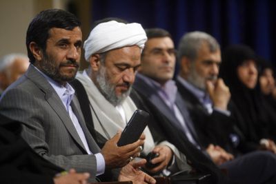 In this image issued Tuesday by the semi-official Iranian Students News Agency, Iran’s President Mahmoud Ahmadinejad, left, attends a meeting with lawmakers  in Tehran, Iran.  (Associated Press / The Spokesman-Review)