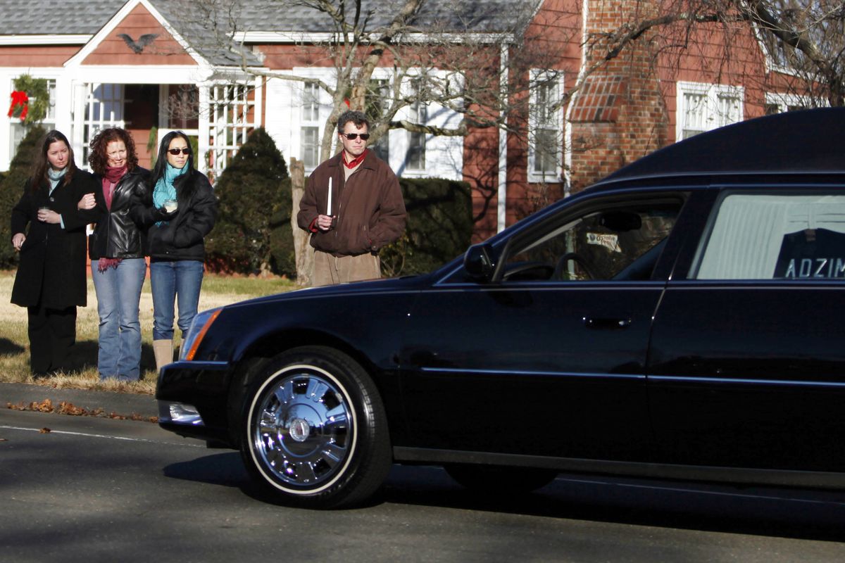 A hearse bearing the body of Victoria Soto drives past a group of onlookers as it arrives for her funeral service at Lordship Community Church, Wednesday, Dec. 19, 2012, in Stratford, Conn.  Soto was killed when a gunman forced his way into Sandy Hook Elementary School in Newtown,  Dec.14,  and opened fire, killing 26 people, including 20 children. (Jason Decrow / Fr103966 Ap)