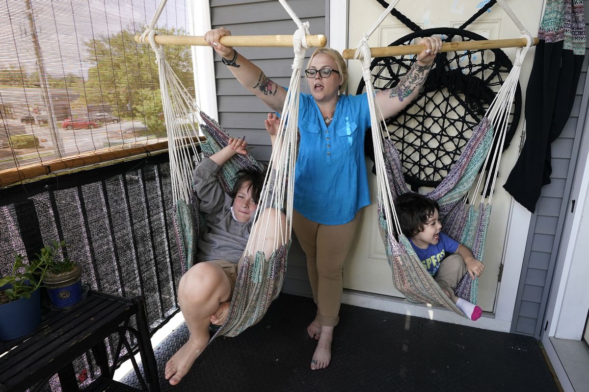 Christina Darling plays with her sons Kayden, 10, left, and Brennan, 4, on Wednesday at home in Nashua, N.H. (Elise Amendola)