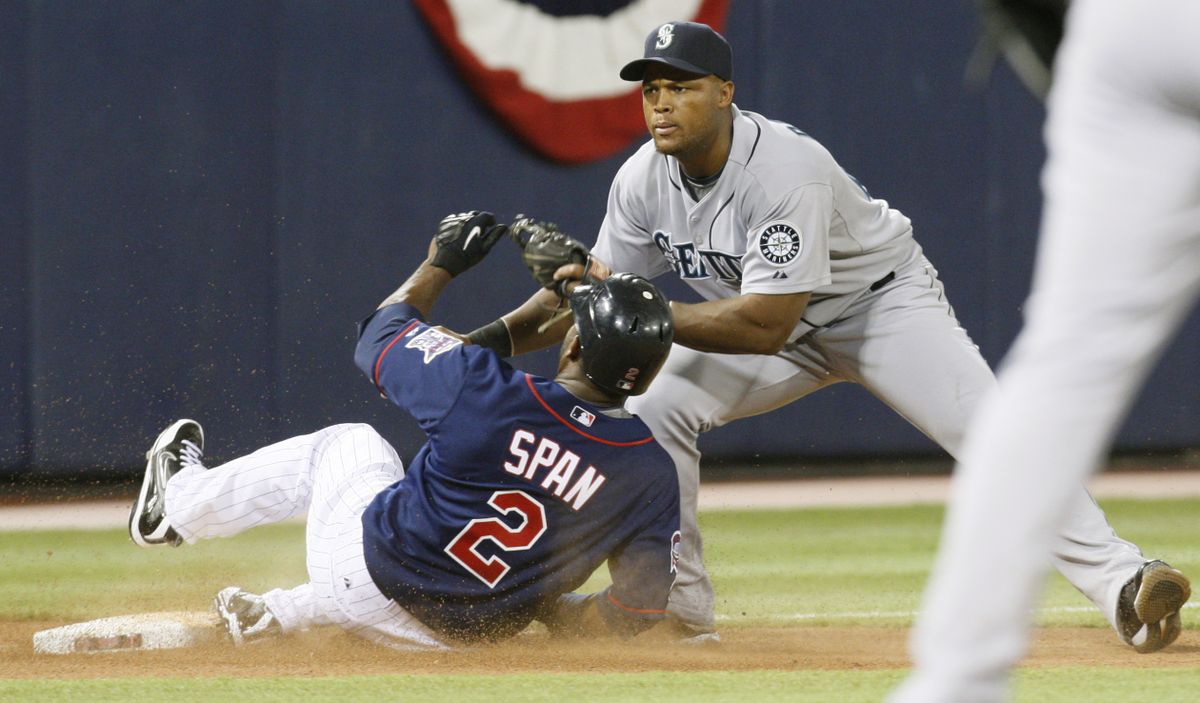 Minnesota’s Denard Span slides into the tag and is out at third as Seattle’s Adrian Beltre makes the play in the fifth inning.  (Associated Press / The Spokesman-Review)