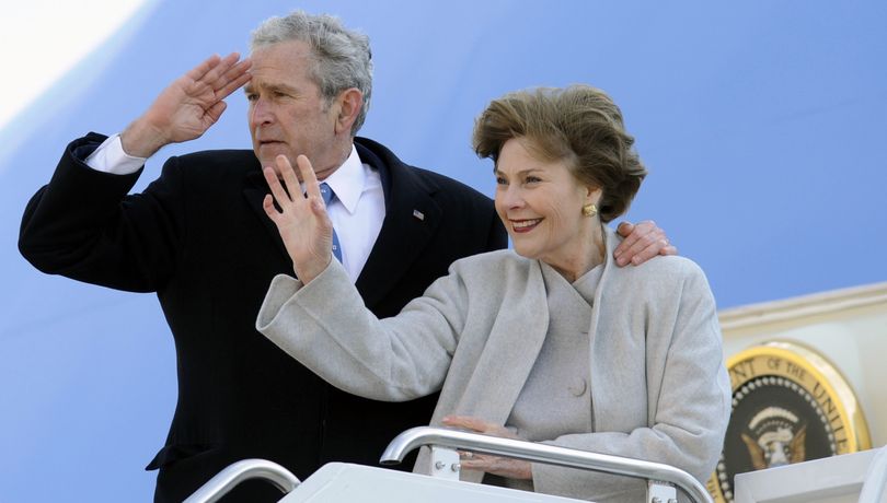 ORG XMIT: MDNW203 ***RETRANSMISSION FOR ALTERNATIVE CROP***Former President George W. Bush, left, salutes and his wife Laura Bush waves as they depart Andrews Air Force Base, Md.  Tuesday, Jan. 20, 2009.  (AP Photo/Nick Wass) (Nick Wass / The Spokesman-Review)