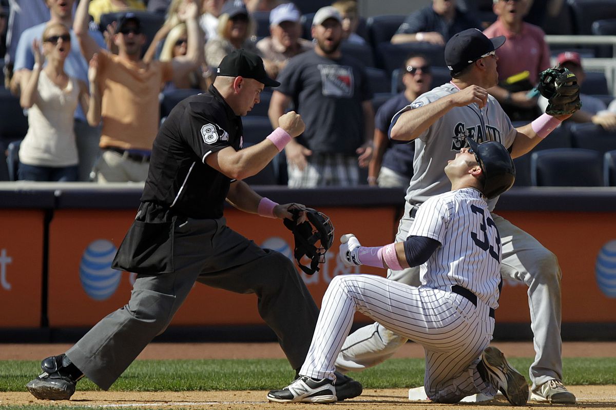 New York’s Nick Swisher reacts after being tagged out at third base by Seattle’s Alex Liddi in the ninth inning Sunday at Yankee Stadium. (Associated Press)