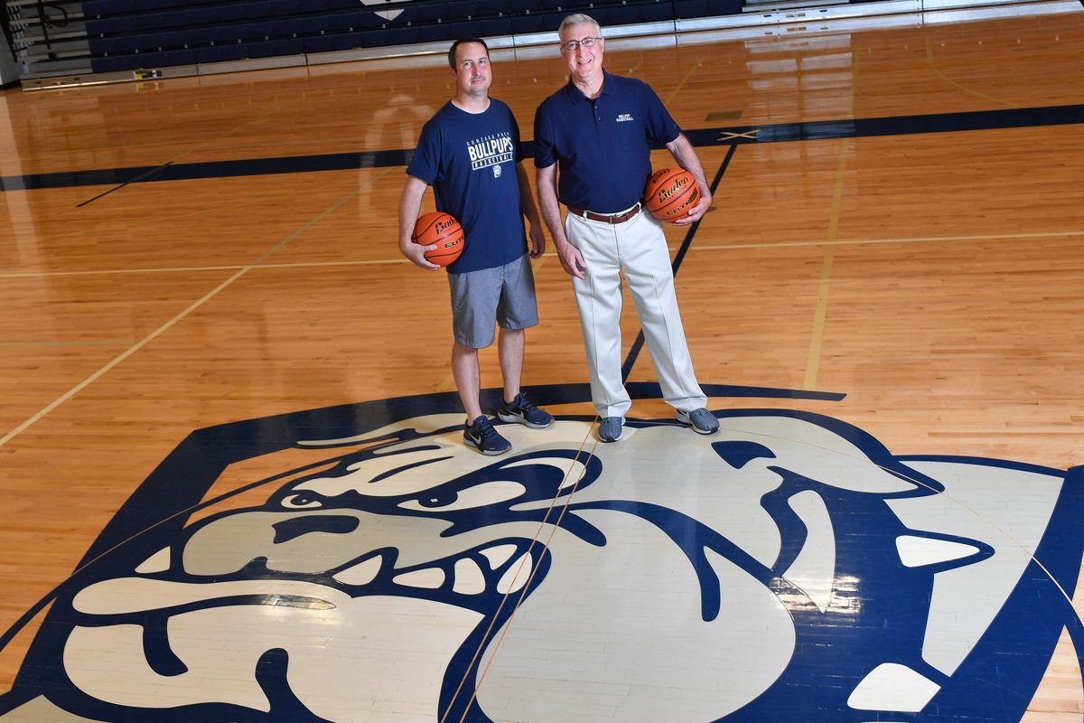 Retiring Gonzaga Prep girls basketball coach Mike Arte, right, poses for a photo with his son Geoff Arte, the new G-Prep girls coach, on July 8 at Gonzaga Prep. Mike Arte led the program for 34 years and guided the Bullpups to an 18-5 record in his final season.  (Tyler Tjomsland/The Spokesman-Review)