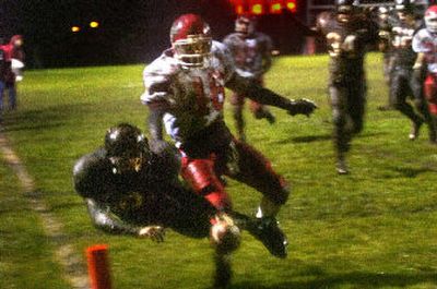 
Cheney's Donny McKee dives for a touchdown before Clarkston's Eric Entel can push him out of bounds Thursday night at Cheney. 
 (Jed Conklin / The Spokesman-Review)