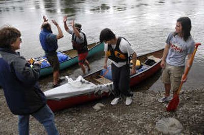 Cheney resident Joanie Davis, left, beams at her sons and first-place finishers, Brian and Jeff, while John Thurston and his father, Fuzzy,  of  Nine Mile Falls, congratulate each other on second place at the end of the Spokane River Canoe Classic marathon race Sunday. 
 (Photos by Holly Pickett / The Spokesman-Review)