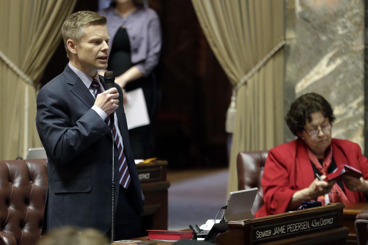 Sen. Jamie Pedersen, left, D-Seattle, speaks during debate on the Senate floor, Thursday, March 8, 2018, at the Capitol in Olympia, Wash., on the final day of the regular session of the Legislature. Lawmakers in the Senate were discussing a compromise measure designed to make it easier to prosecute police who commit reckless or negligent shootings in Washington state. On Friday, April 20, a Thurson County Superior Court judge ruled the procedure they used violated the Constitution. (Ted S. Warren / Associated Press)