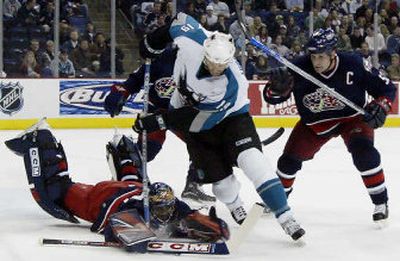 
Adam Foote, right, tries to clear San Jose's Joe Thornton as Columbus goaltender Marc Denis dives on a loose puck. 
 (Associated Press / The Spokesman-Review)