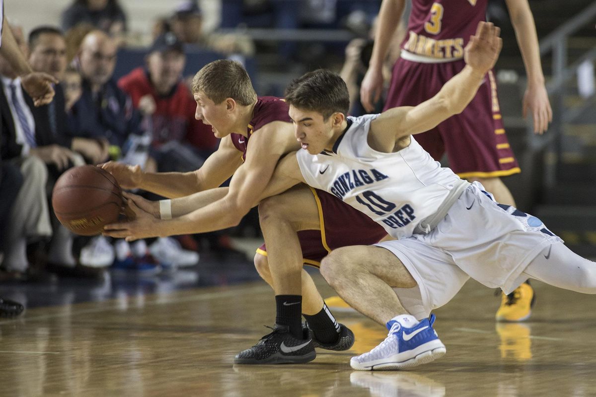 Gonzaga Prep’s Kea Vargas, right, fights for a loose ball with Enumclaw’s Kale Engebretsen Thursday, March 2, 2017, during the quarterfinals of the 4A Boys Washington State Basketball Tournament in Tacoma. Gonzaga Prep won 53-30 to advance. (Patrick Hagerty / For The Spokesman-Review)