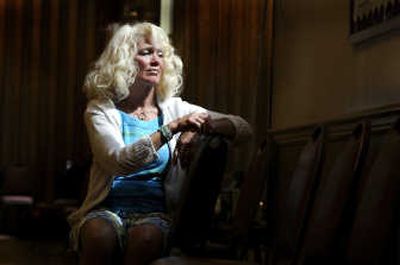 
Sandy Ross sits for a reflective moment after leading an aerobics session at Sinto Senior Center. Ross will participate in the Out of the Darkness Overnight Walk in Seattle next month in memory of her two sons, who died of suicide. 
 (Christopher Anderson / The Spokesman-Review)