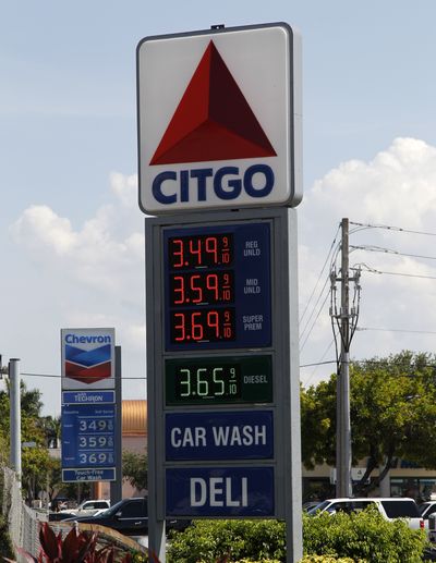 Gas prices are advertised at competing gas stations Thursday in Miami. The Labor Department said Thursday that U.S. consumer prices fell in May by the most since December 2008, pulled down by lower gas prices. (Associated Press)