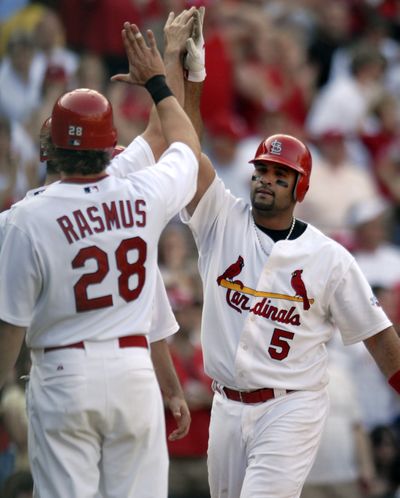 St. Louis’ Albert Pujols receives congratulations after one of his two grand slams this season.  (Associated Press / The Spokesman-Review)