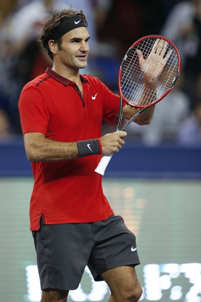 Roger Federer celebrates as he advances at the Shanghai Masters Tennis Tournament. (Associated Press)