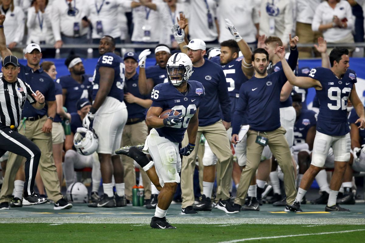 Penn State running back Saquon Barkley (26) breaks free for a 92-yard touchdown run during the first half of the Fiesta Bowl NCAA college football game against Washington, Saturday, Dec. 30, 2017, in Glendale, Ariz. (Ross D. Franklin / Associated Press)