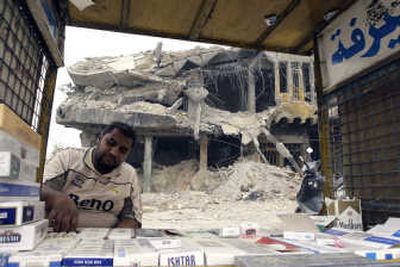 A man sells cigarettes in front of a destroyed building in the Shiite stronghold of Sadr City on July 1. Associated Press
(Associated Press / The Spokesman-Review)
