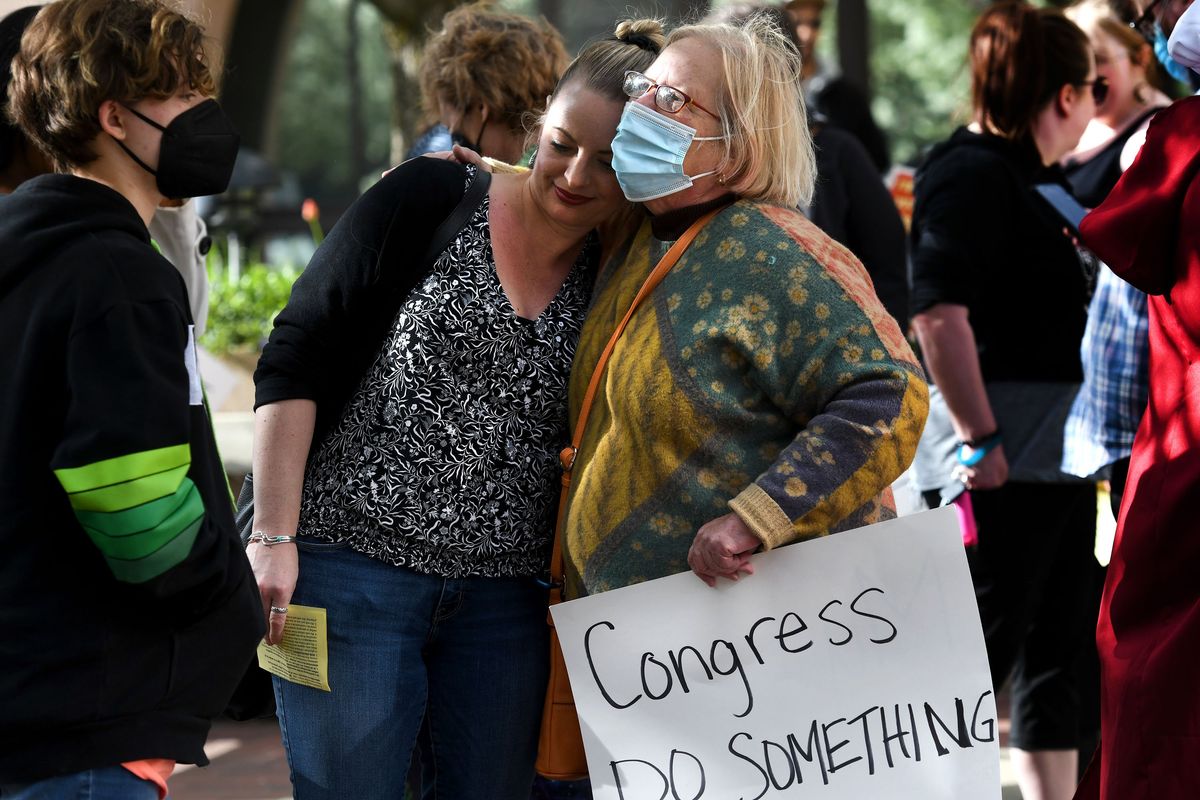 Aileen Luppert, left, gets a hug from her aunt, Eve Luppert, during the abortion rights rally Tuesday in front of the Thomas S. Foley U.S. Courthouse in Spokane.  (kathy plonka)
