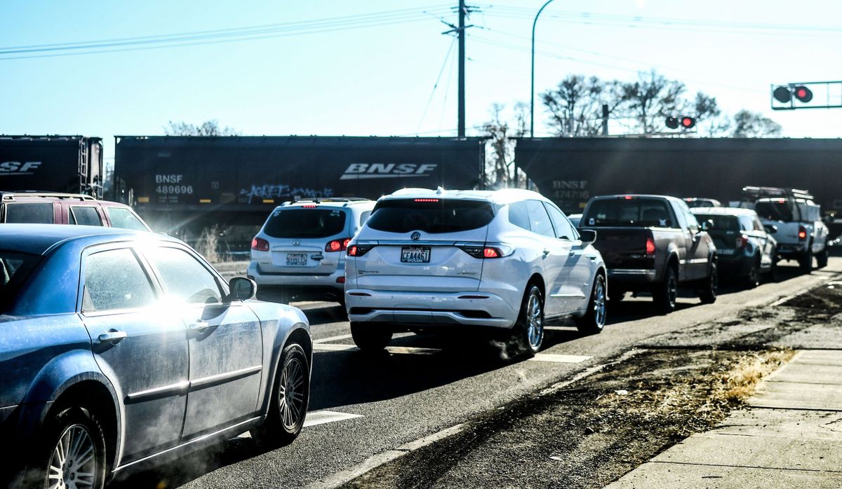 Traffic is lined up at the railroad crossing at Trent Avenue and Pines Road in November. Spokane Valley may need to use eminent domain to acquire land needed to build an underpass that will eliminate delays at the crossing.  (Kathy Plonka/The Spokesman-Review)