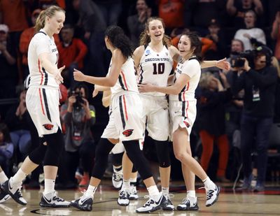 From left to right, Oregon State's Joanna Grymek, Taya Corosdale, Katie McWilliams and Aleah Goodman (1) celebrate their win over Boise State in a first-round game of the NCAA women's college basketball tournament in Corvallis, Ore., Saturday, March 23, 2019. (Amanda Loman / AP)