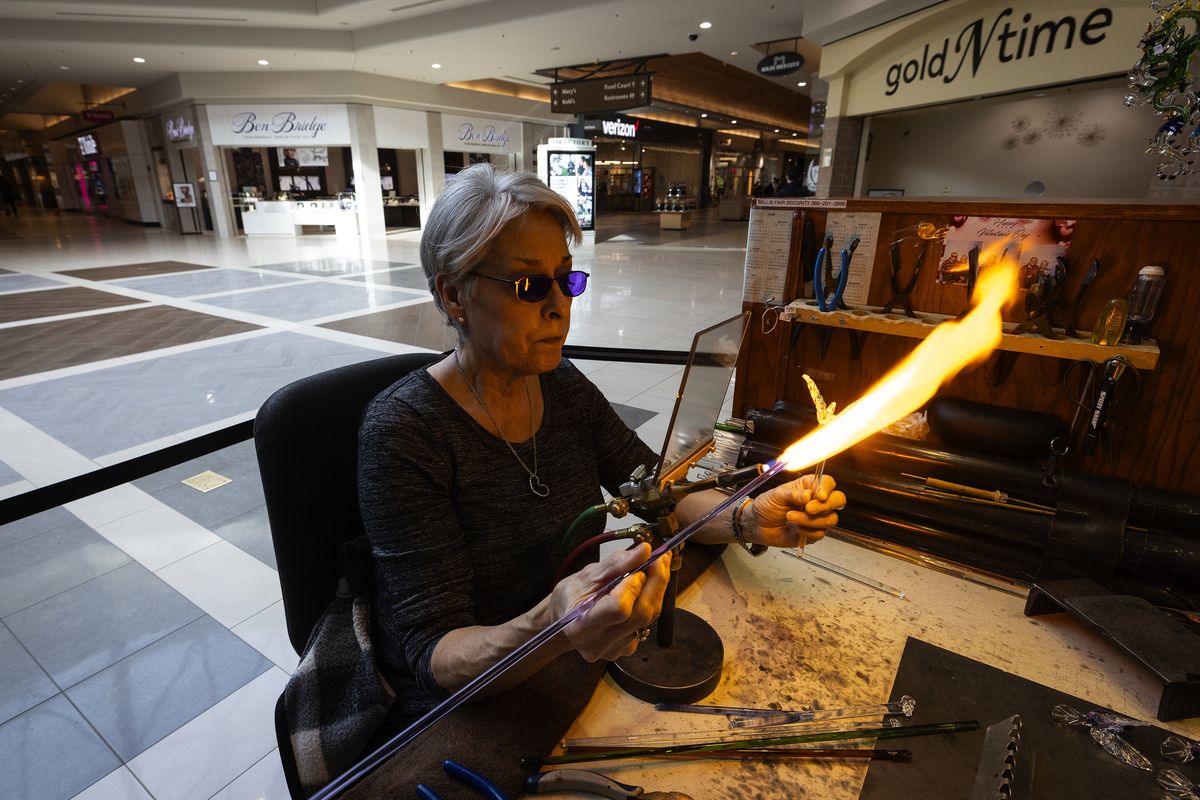 Christine Anderson, who owns Anderson Glass with her husband Gordon Anderson, makes a hummingbird ornament inside the Bellis Fair mall, known to be popular among Canadians, on Feb. 26 in Bellingham. (Ken Lambert/The Seattle Times/TNS)