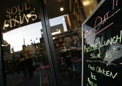 A sign advertising a “Bailout/Rescue Lunch Special” is seen in front of Soul Fixins’ restaurant in New York on Wednesday.  (Associated Press / The Spokesman-Review)