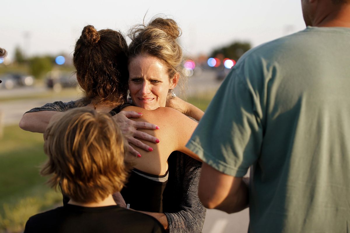 Jennifer Stong hugs Tasha Hunt outside the scene of a shooting on the east side of Lake Hefner in Oklahoma City, Thursday, May 24, 2018. Stong was inside the restaurant when the shooting occurred. (Bryan Terry / The Oklahoman)