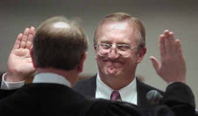 
Ralph Baker takes the oath of office for Spokane County assessor on Tuesday afternoon, replacing Duane Sommers. 
 (Christopher Anderson/ / The Spokesman-Review)