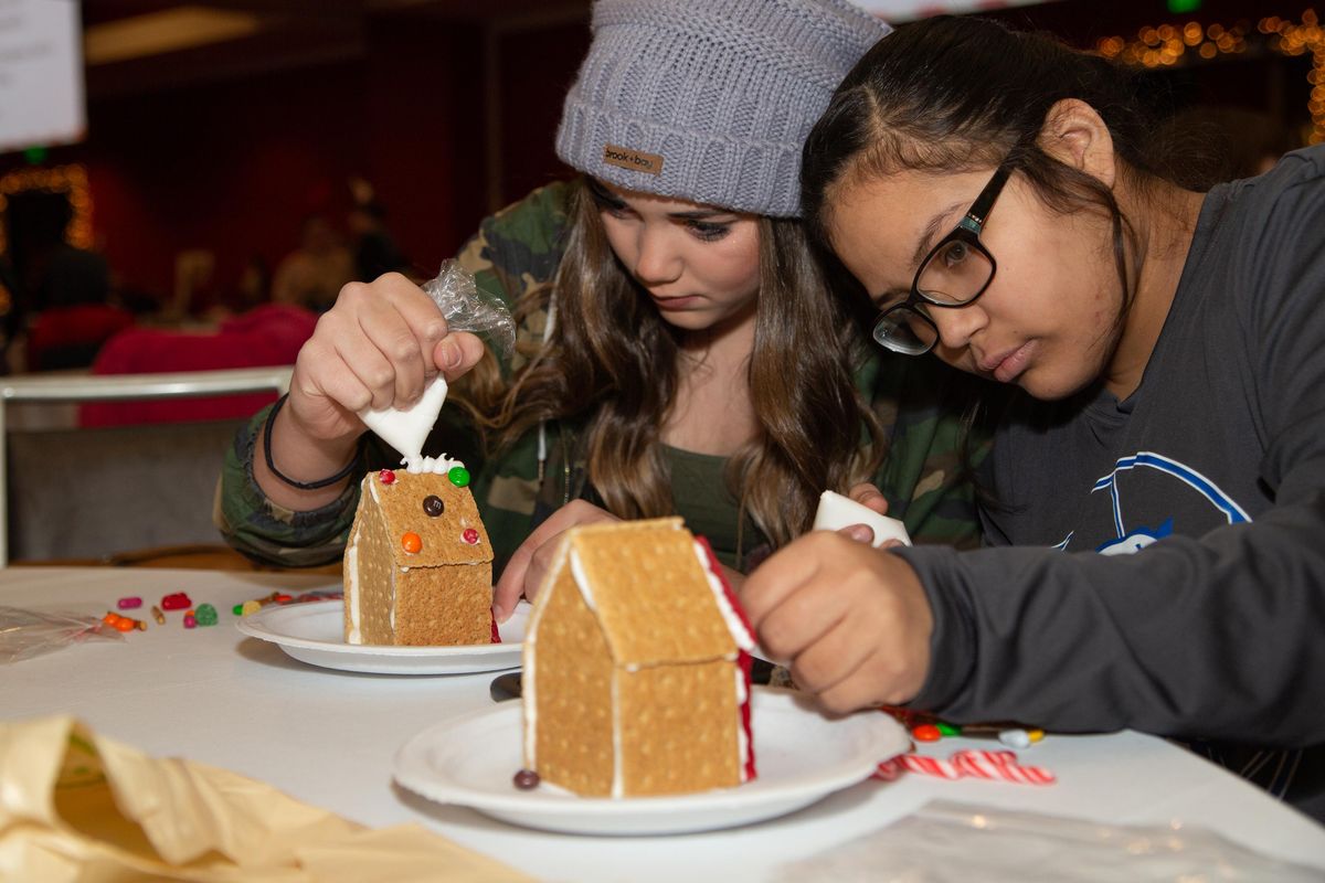 13-year-olds Truly Elliott and Shelby Mustang decorate gingerbread houses at the Davenport Grand on Dec. 9, 2018. The event featured family gingerbread building, photos with a life-sized gingerbread man and woman, and professional competitors. (Libby Kamrowski / The Spokesman-Review)