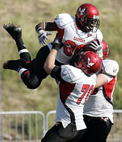 EWU running back Darriell Beaumonte celebrates his touchdown with lineman Steven Forgette (70).  (Nick Short)