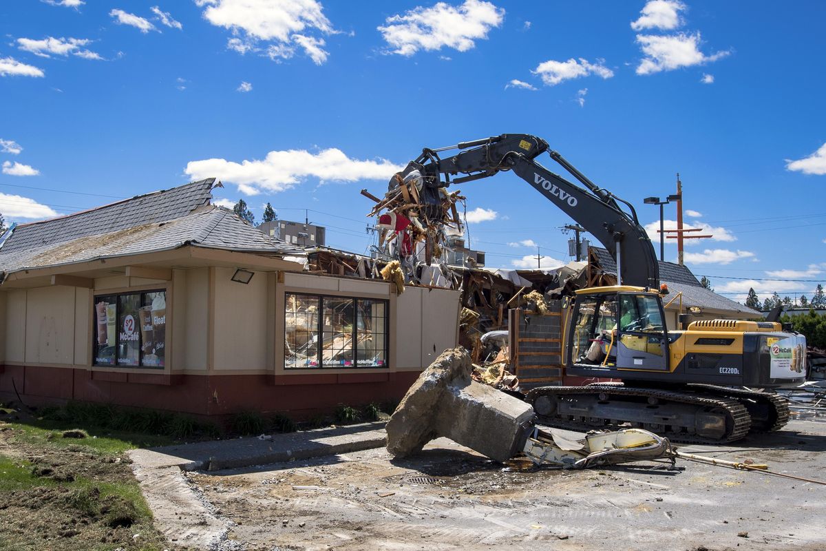 Equipment operator Ken Woods with Larson’s Demolition tears down the McDonald’s at 6321 N. Monroe St. on Wednesday. It was Spokane’s first McDonald’s. Pieces of the 1963 store are encased inside a 1979 remodel and expansion. It is being demolished to make way for a new store with double drive-through lanes and will open in September. (Colin Mulvany / The Spokesman-Review)