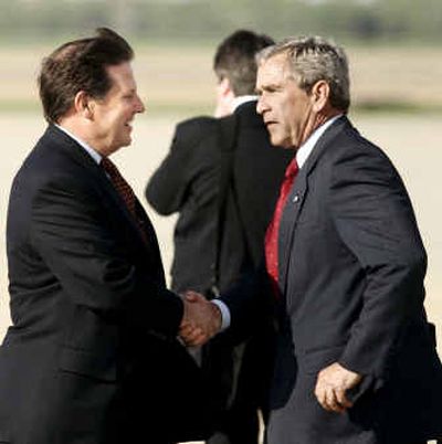 
President Bush shakes hands with House Majority Leader Tom DeLay, R-Tex., after landing Tuesday at Andrews Air Force Base, Md., on Tuesday. 
 (Associated Press / The Spokesman-Review)