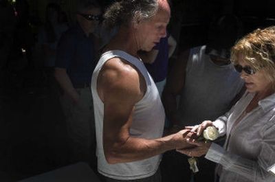 
Rod Christensen receives a rose on Friday at the memorial service for his guide dog, Justice, who was killed on Tuesday by a truck while walking with Christensen. 
 (Jed Conklin / The Spokesman-Review)